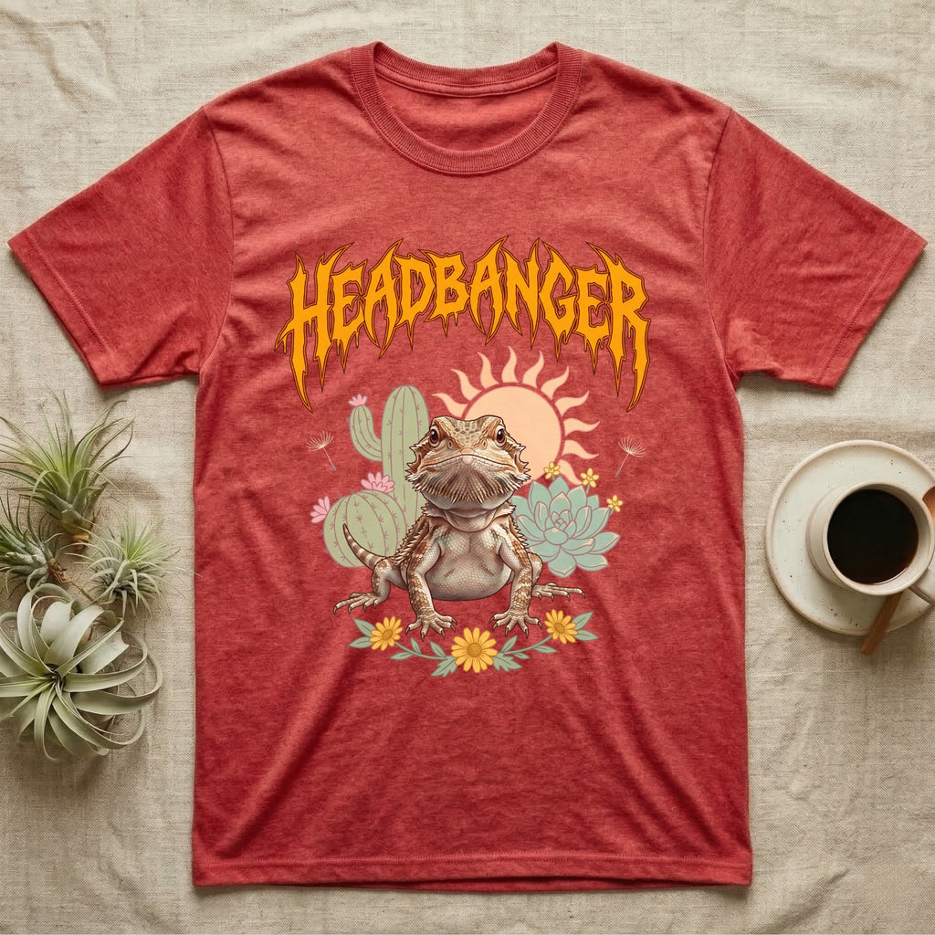 Central Bearded Dragon Feral T-Shirt in Heather Red — Baby bearded dragon in a pastel desert scene under a spiky amber metal wordmark reading HEADBANGER.
