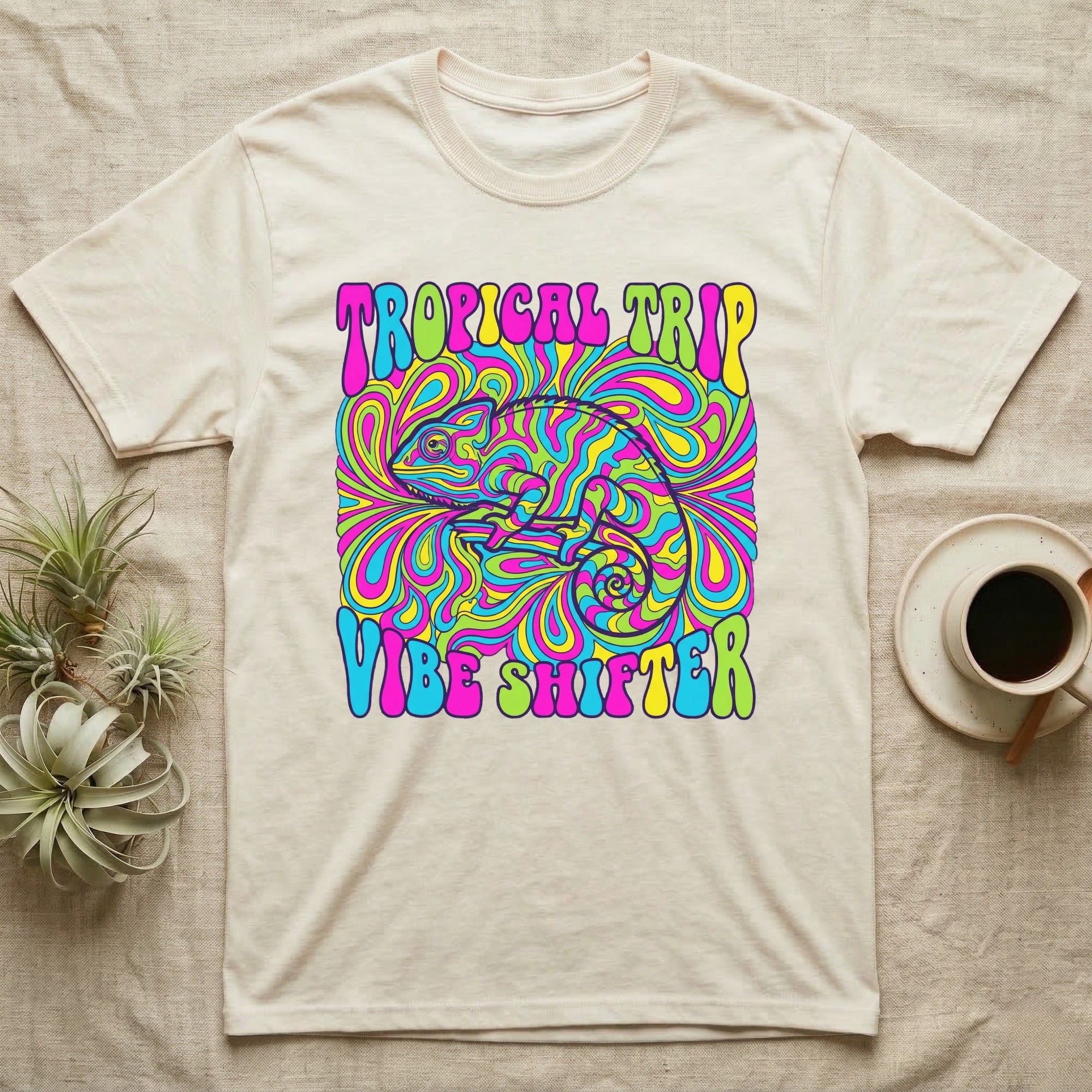 Cream t-shirt with psychedelic chameleon design and text "Tropical Trip Vibe Shifter".