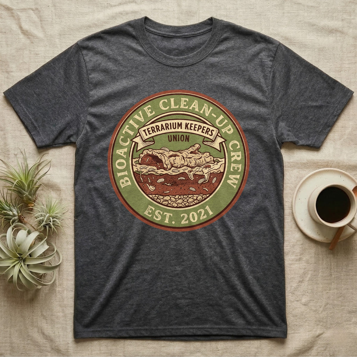 Isopod Terrarium Keepers Union T-Shirt in Dark Heather — Vintage union badge showing a cross-sectioned bioactive vivarium worked by isopods and springtails.