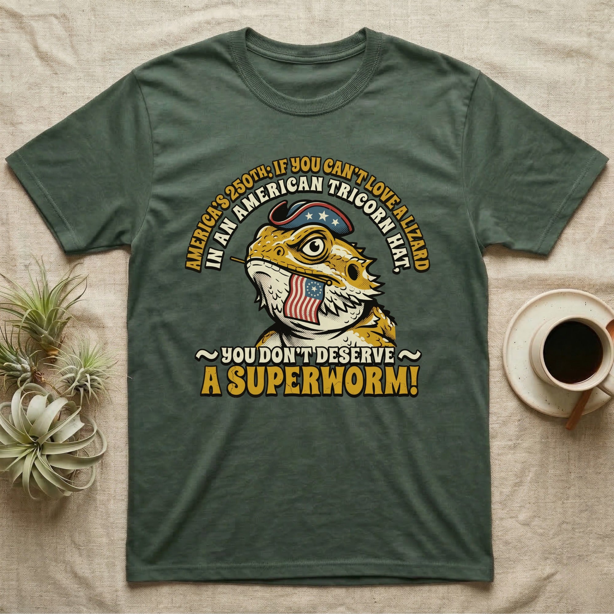 Bearded Dragon Tricorn Tee in Military Green — Bold woodcut tee of a bearded dragon in a colonial tricorn hat, gold and cream text reading You Don't Deserve A Superworm, on black.