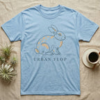 Light blue t-shirt with minimalist bunny design and text "URBAN FLOP".