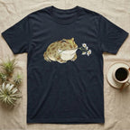 Pacman Frog Blossom T-Shirt in Navy — Watercolor illustration of an olive-tan Pacman frog holding a water-lily blossom sprig, on a dark grey t-shirt.