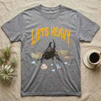 Rhino Beetle Feral T-Shirt in Sport Grey — Horned rhinoceros beetle standing head-on below a dripping amber-gold metal "Lifts Heavy" wordmark
