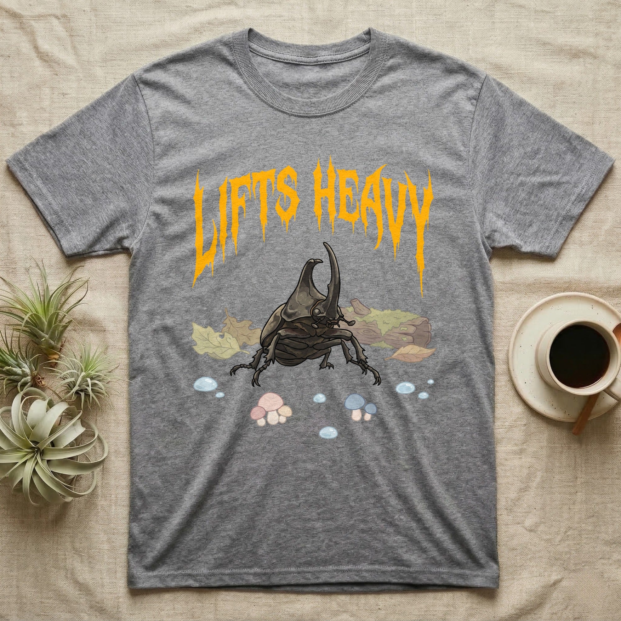 Rhino Beetle Feral T-Shirt in Sport Grey — Horned rhinoceros beetle standing head-on below a dripping amber-gold metal "Lifts Heavy" wordmark
