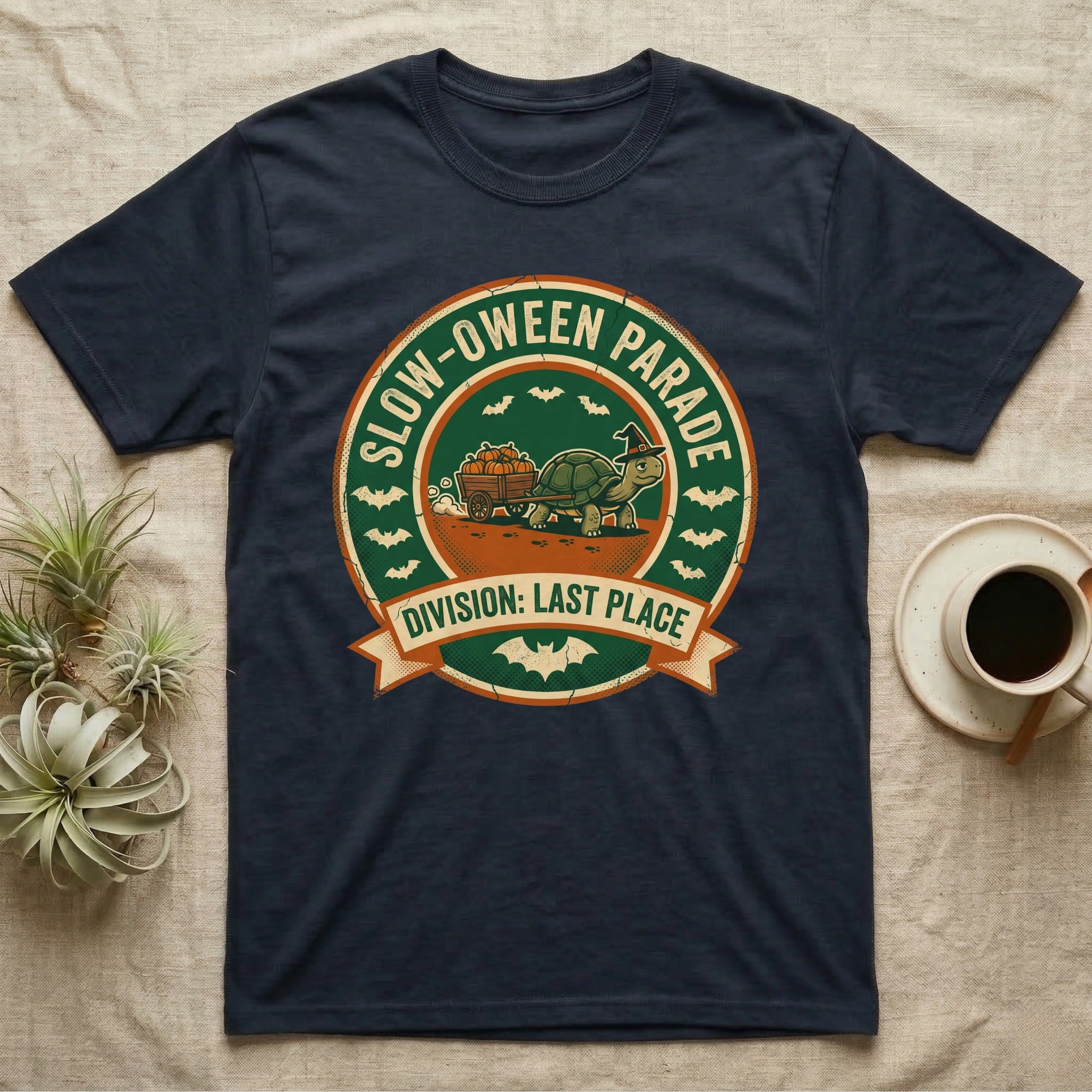 Tortoise Slow-oween Parade T-Shirt in Navy — Distressed badge of a witch-hatted tortoise pulling a pumpkin wagon, "Slow-oween Parade, Division Last Place."