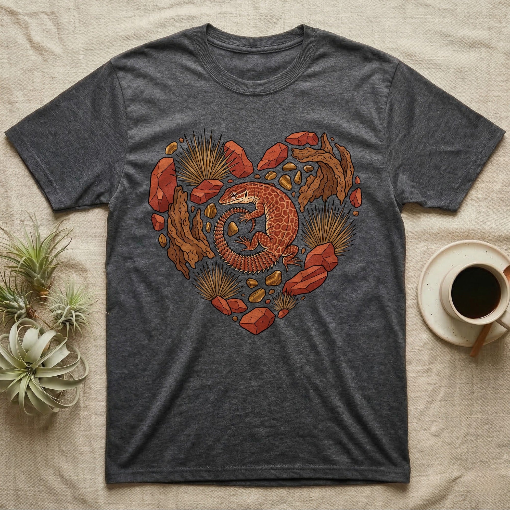 Dark gray t-shirt with a heart-shaped desert lizard and rock art design.