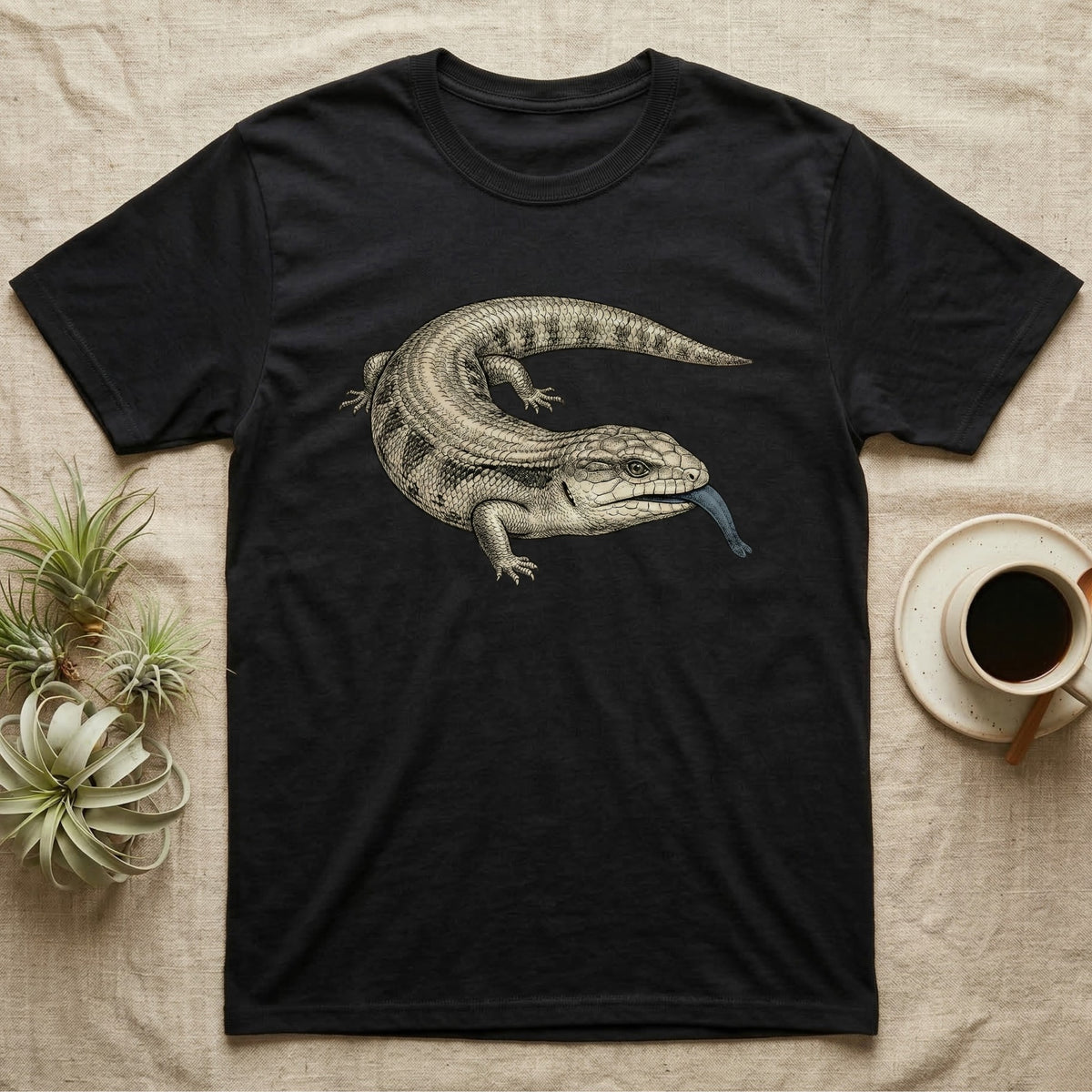 Black t-shirt with a blue-tongued lizard illustration.