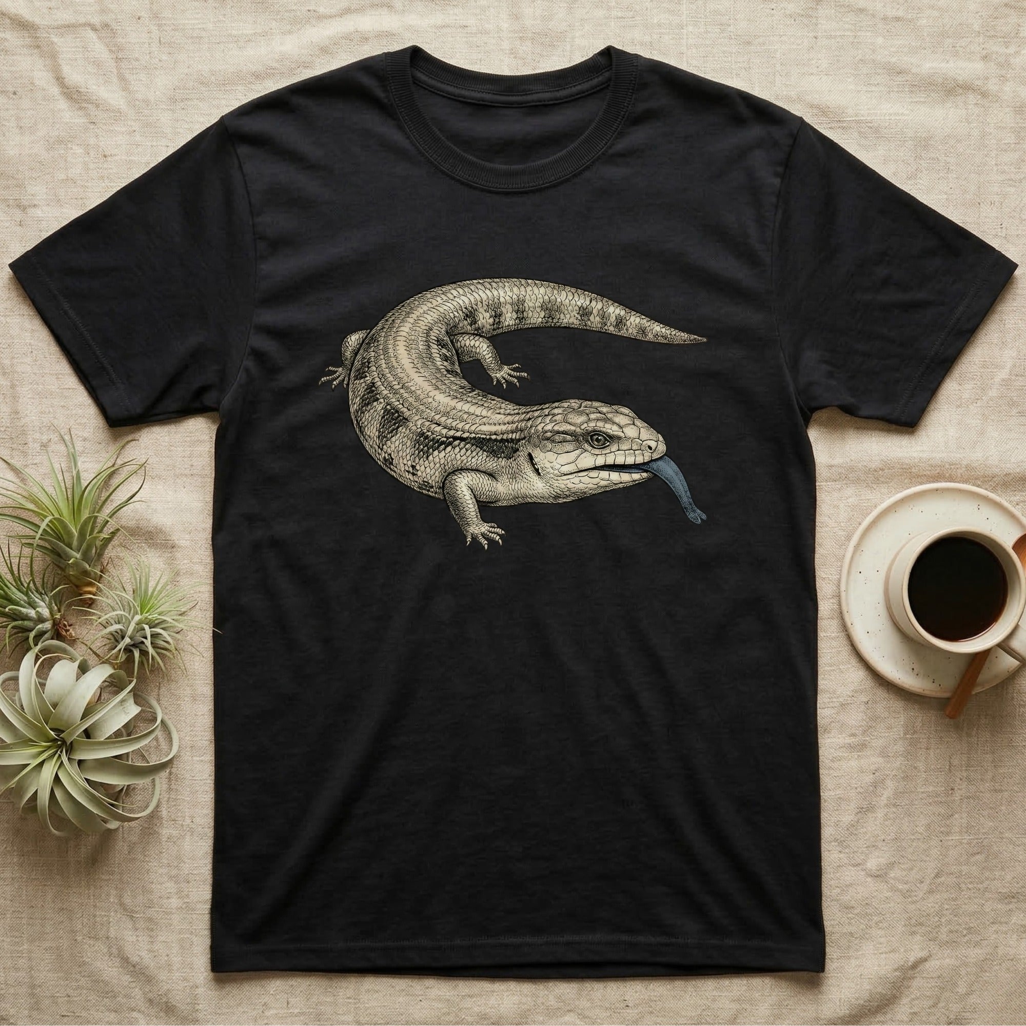 Black t-shirt with a blue-tongued lizard illustration.