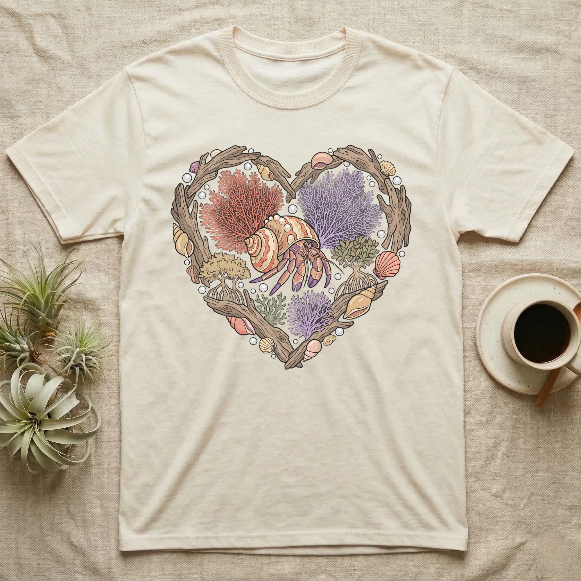 Cream t-shirt with heart design featuring coral, shells, and a hermit crab.