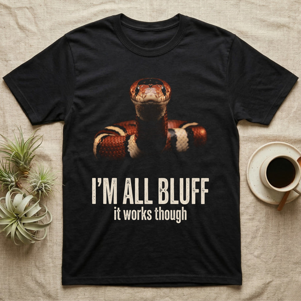 Deadpan mugshot of a banded milk snake on black, captioned I'm all bluff, it works though. — shown on a Black tee.