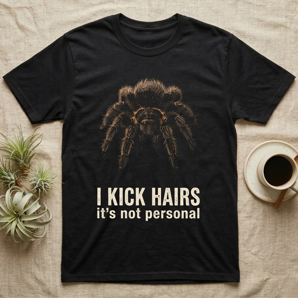 Deadpan photographic mugshot of a curly hair tarantula facing the camera above the distressed text I Kick Hairs, it's not personal. — shown on a Black tee.