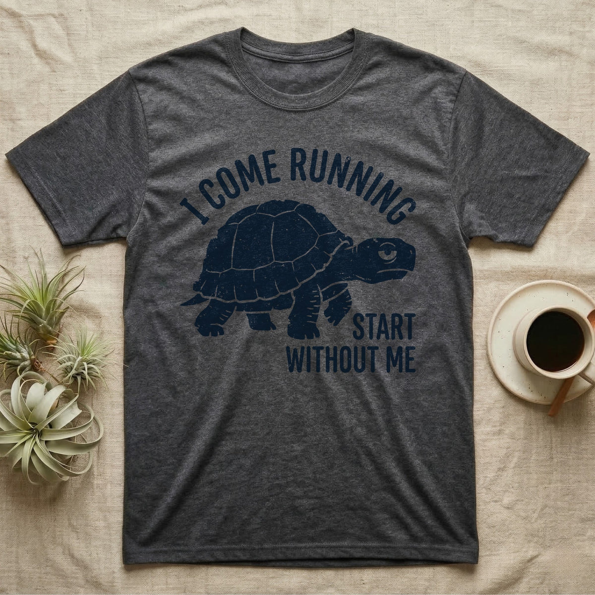 Red-Foot Tortoise Running T-Shirt in Dark Heather — Navy silhouette of a red-footed tortoise walking under arched words I Come Running, beside Start Without Me