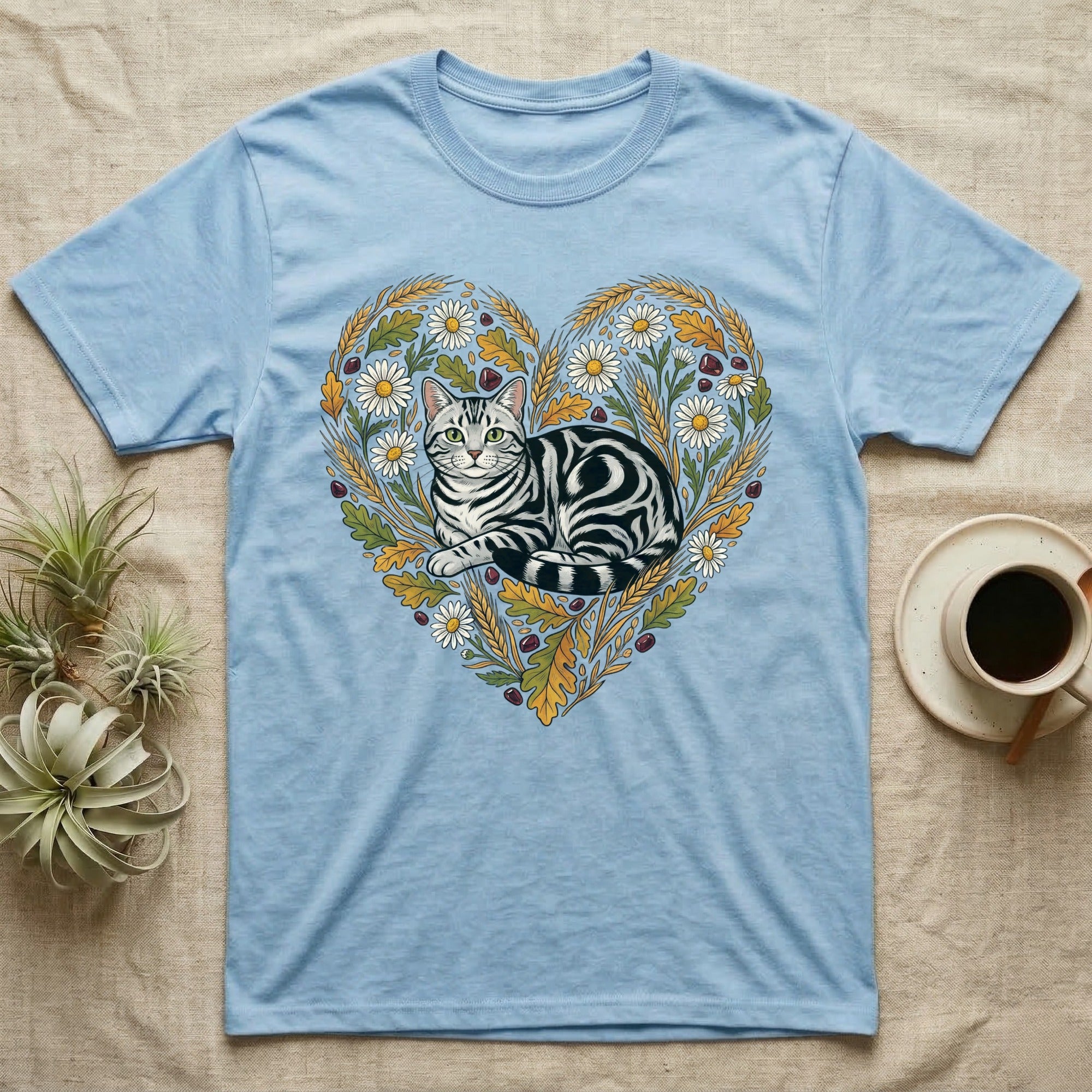 Light blue t-shirt with a tabby cat inside a floral heart design.