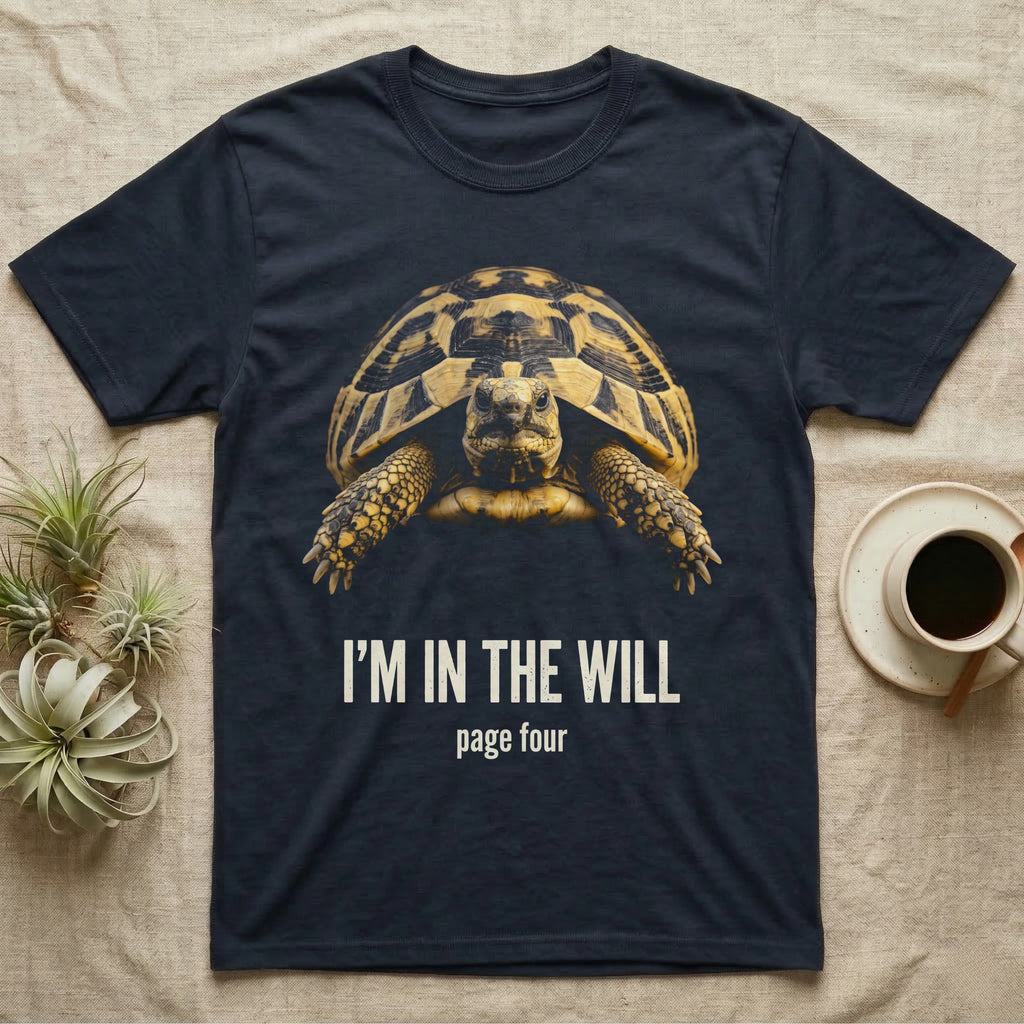 Flat-black mug-shot portrait of a Hermann's tortoise peering from its domed shell, with the printed words I'm In The Will, page four. — shown on a Navy tee.