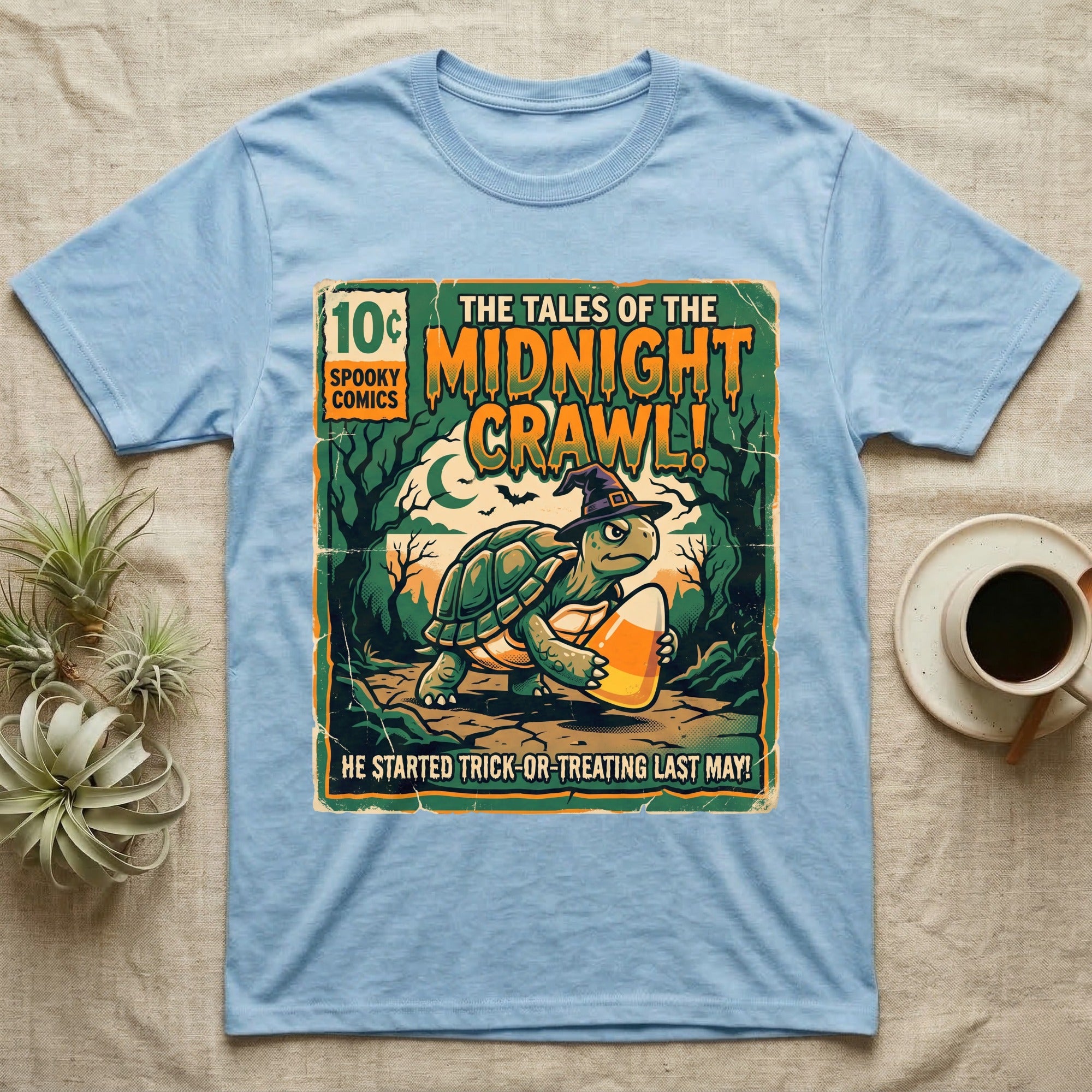 Tortoise Midnight Crawl Comic T-Shirt in Light Blue — Vintage comic cover of a witch-hatted tortoise with candy corn in a moonlit forest, "Tales of the Midnight Crawl."