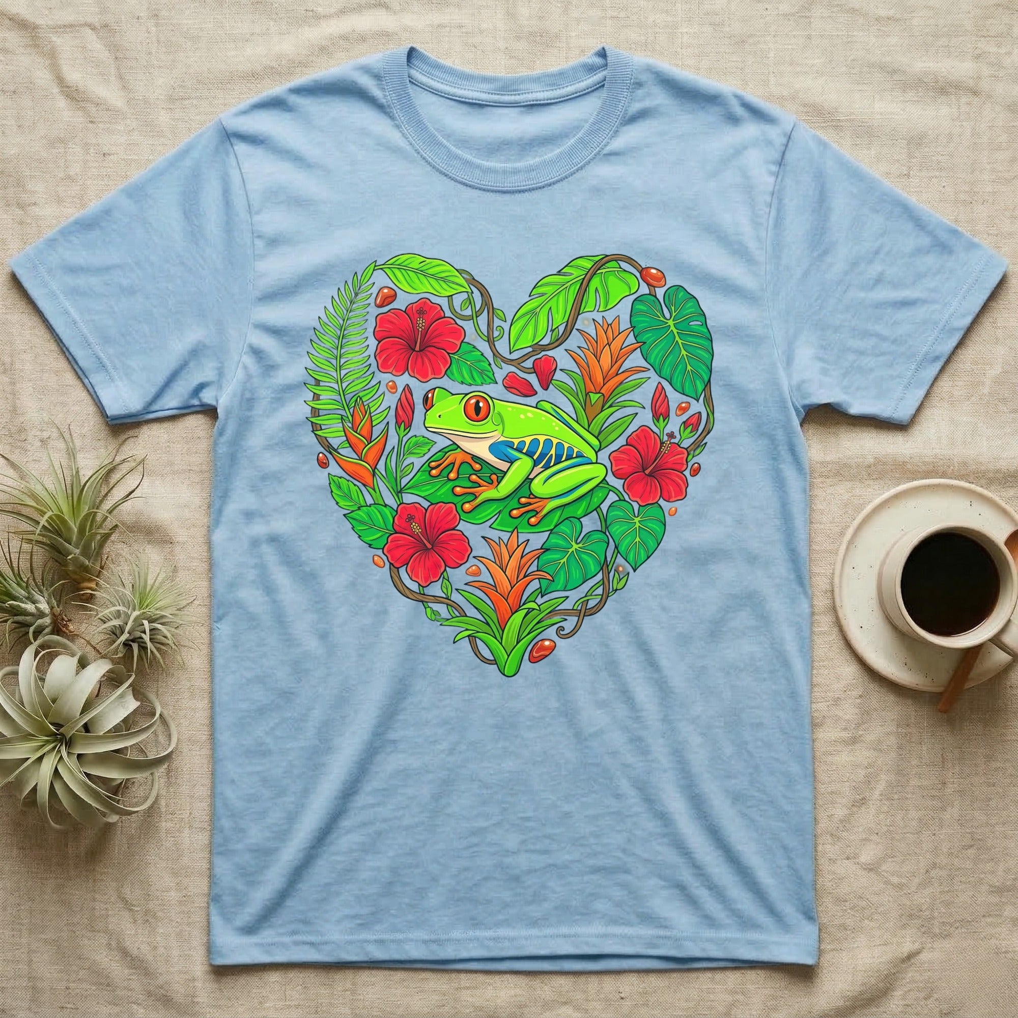 Light blue t-shirt with a heart-shaped tropical foliage and frog design.