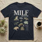 Budgett's Frog MILF T-Shirt in Navy — Seven Budgett's frogs in a cut-out photo collage under the huge cream word MILF, man I love budgett's frogs.