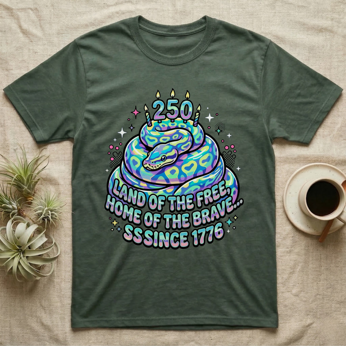 Ball Python Birthday Cake T-Shirt in Military Green — Y2K pastel ball python coiled as a birthday cake with 250 candles and bubble text Land of the Free, Sssince 1776.