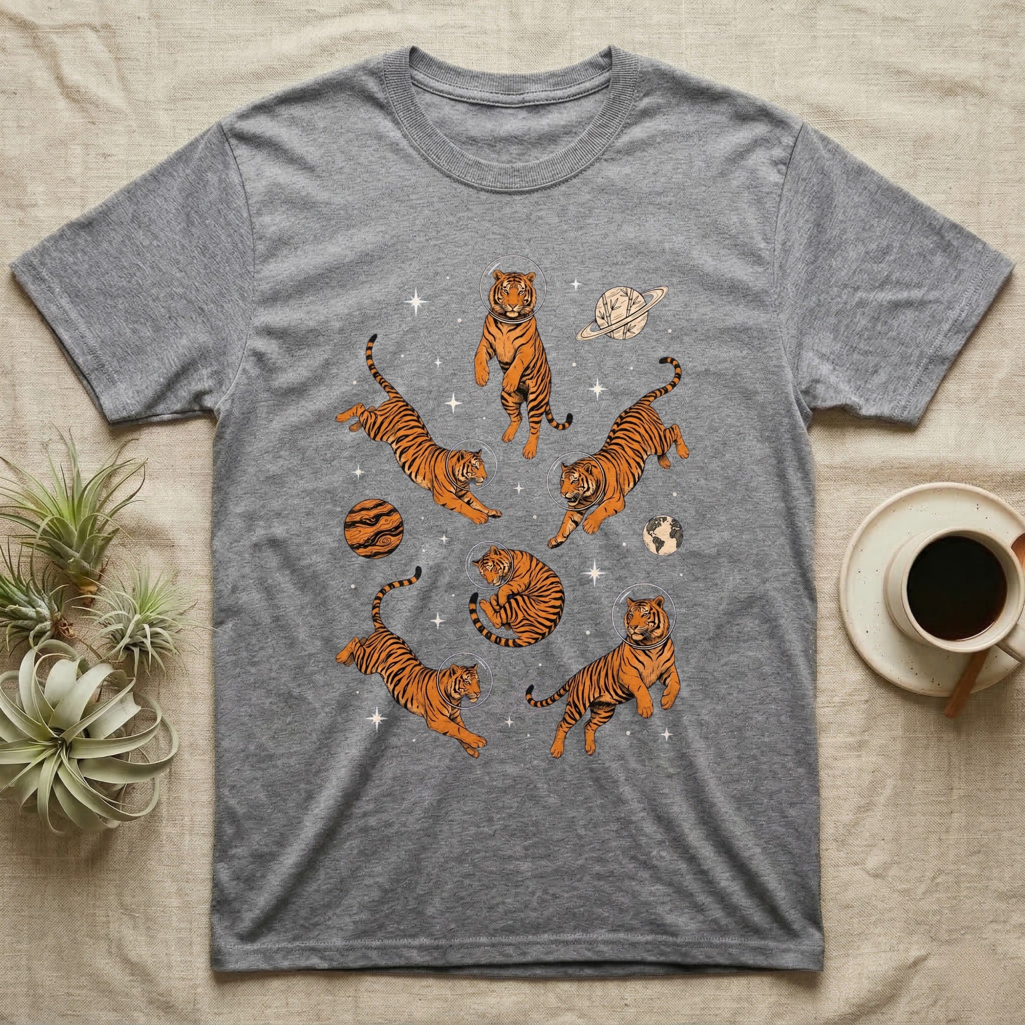 T-shirt with cartoon tigers floating among planets and stars.