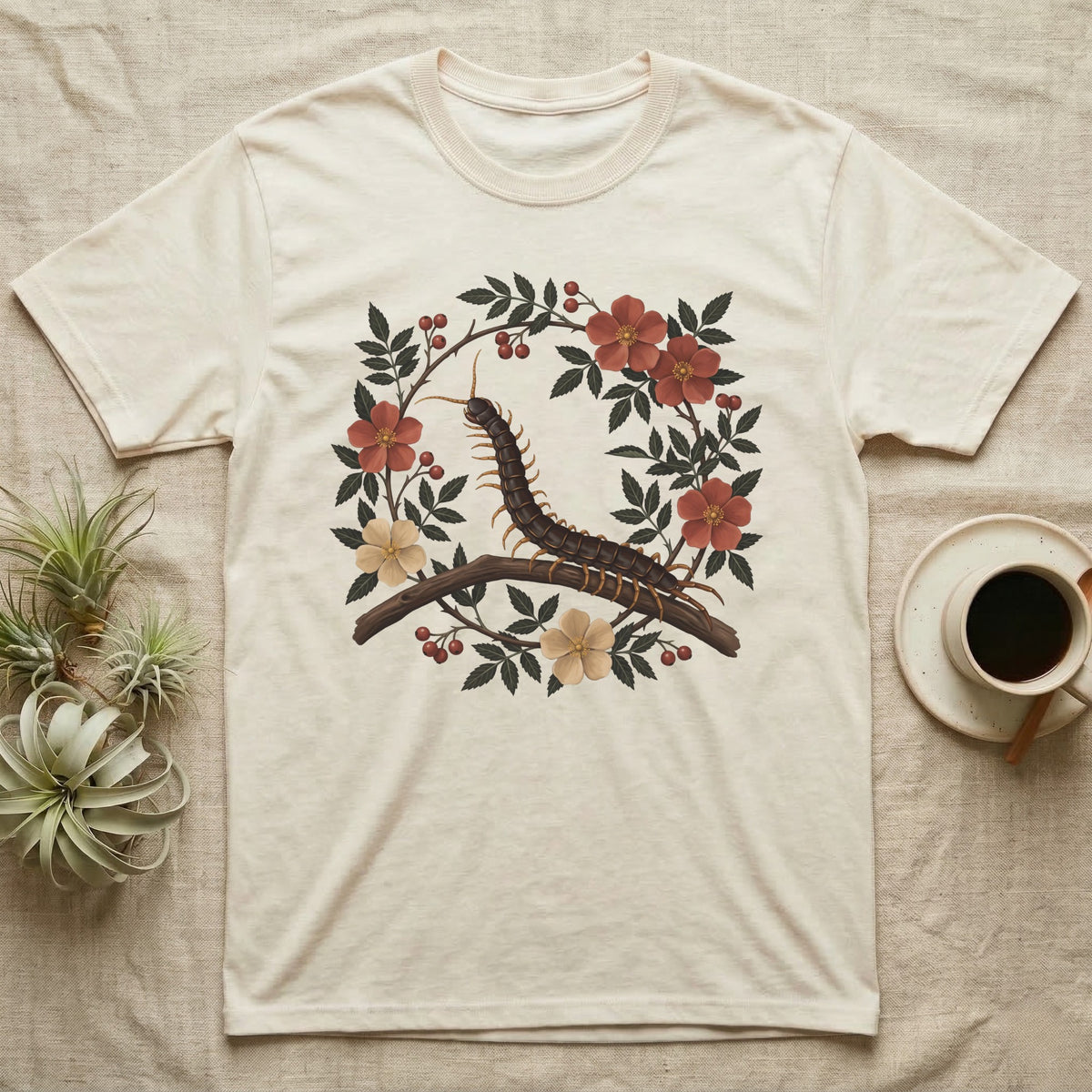 Vietnamese Centipede Botanical T-Shirt in Natural — Vietnamese giant centipede painted in matte oil, in profile on a branch inside an oval bower of flowering bramble.