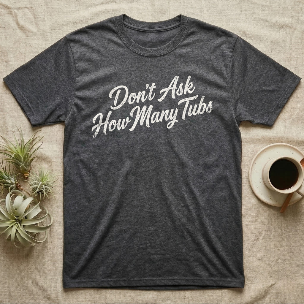 Snake Tubs T-Shirt in Dark Heather — Worn off-white 1970s retro brush script climbing a diagonal on charcoal, reading Don't Ask How Many Tubs