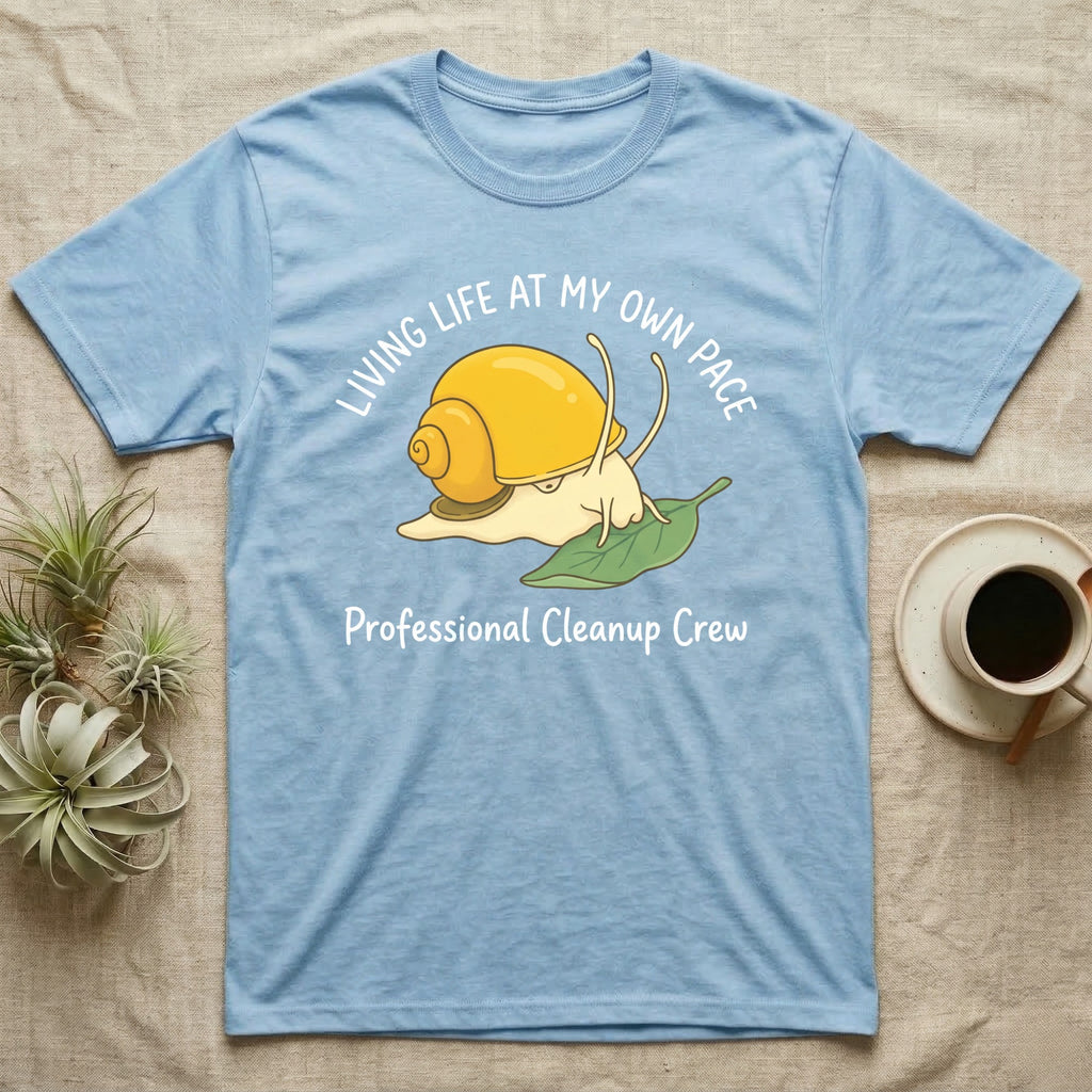 Light blue t-shirt with a cartoon snail and the text "Living Life At My Own Pace Professional Cleanup Crew".
