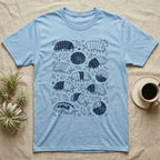 Cubaris Isopod Morph Collection T-Shirt in Light Blue — Deep navy single-ink illustration of Cubaris isopods in varied morph patterns scattered across leaf litter.