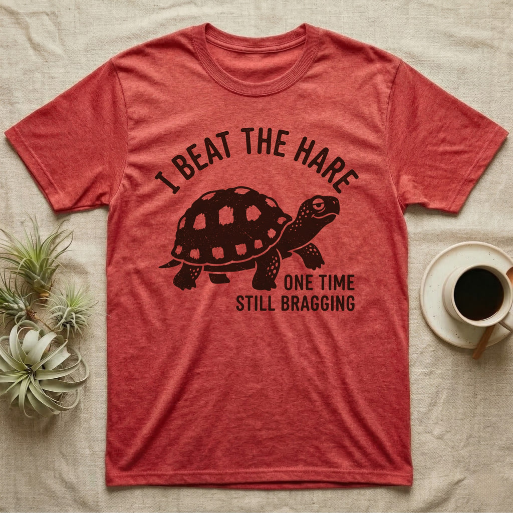 Red-Foot Tortoise Bragging T-Shirt in Heather Red — Smug red-footed tortoise walking chin-up under I Beat the Hare, One Time, Still Bragging