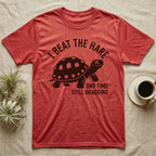 Red-Foot Tortoise Bragging T-Shirt in Heather Red — Smug red-footed tortoise walking chin-up under I Beat the Hare, One Time, Still Bragging