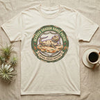 Bearded Dragon Pancake Inspector T-Shirt in Natural — Weathered ranger badge of a bearded dragon flattened on a rock, "Bearded Dragon Range Patrol, Official Pancake Inspector."