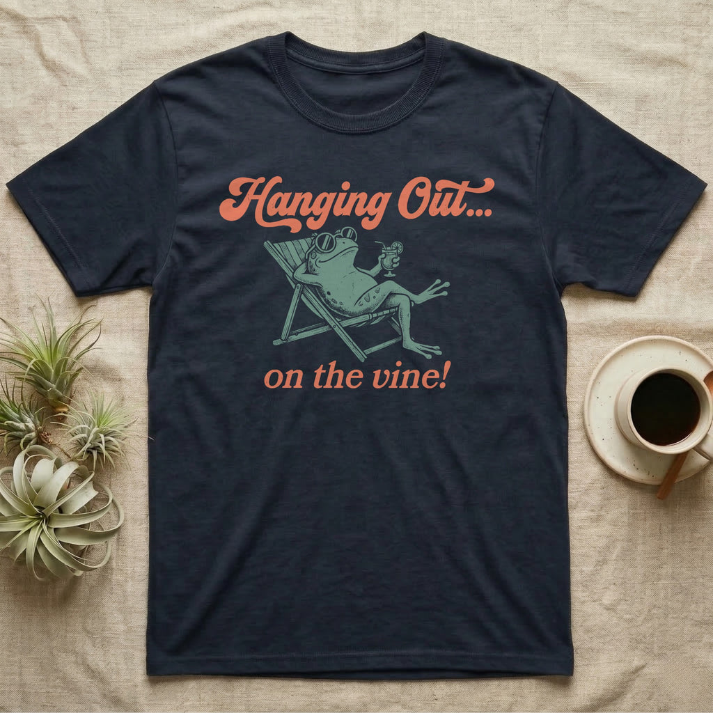 Tomato Frog Vine Vibes T-Shirt in Navy — Illustrated tomato frog reclining in a beach chair with sunglasses and a cocktail, coral script reading Hanging Out On The Vine.