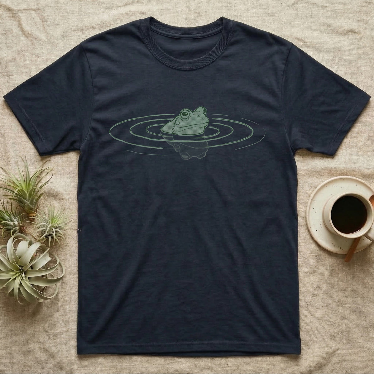 Minimal Swimming Frog T-Shirt in Navy — Minimal single-line illustration of a frog at the waterline with concentric ripple rings and vast negative space.