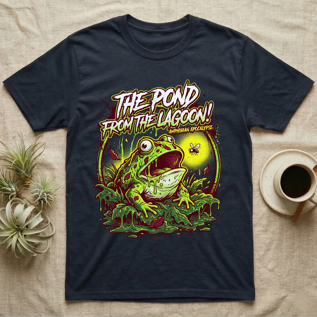 Pacman Frog Lagoon Apocalypse T-Shirt in Navy — B-movie horror poster of a Pacman frog bursting from slime at a fly, "The Pond From the Lagoon, Amphibian Apocalypse."