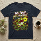 Pacman Frog Lagoon Apocalypse T-Shirt in Navy — B-movie horror poster of a Pacman frog bursting from slime at a fly, "The Pond From the Lagoon, Amphibian Apocalypse."