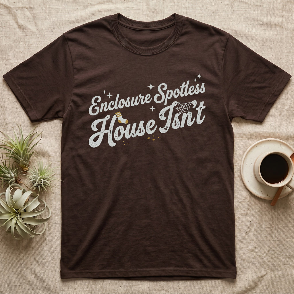Terrarium Spotless House T-Shirt in Dark Chocolate — Retro script reading Enclosure Spotless with sparkles above grubby lettering reading House Isn't with a sock, cobweb and crumbs