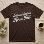 Terrarium Spotless House T-Shirt in Dark Chocolate — Retro script reading Enclosure Spotless with sparkles above grubby lettering reading House Isn't with a sock, cobweb and crumbs