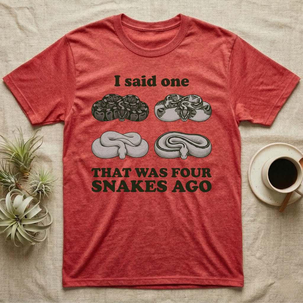 Ball Python Collector T-Shirt in Heather Red — Four engraved ball python morphs in tight coils between the words I said one and THAT WAS FOUR SNAKES AGO.
