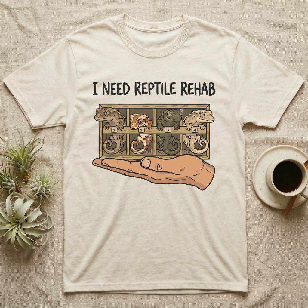 Crested Gecko Rehab T-Shirt in Natural — Vector scene of a hand presenting a rack of four crested geckos under a marker-style reptile rehab caption.