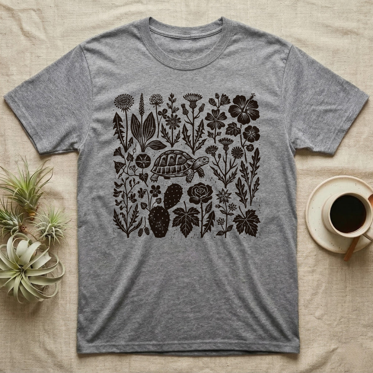 Hermann's Tortoise Forage T-Shirt in Sport Grey — One-ink linocut of twenty forage plants with a small Hermann's tortoise walking among them