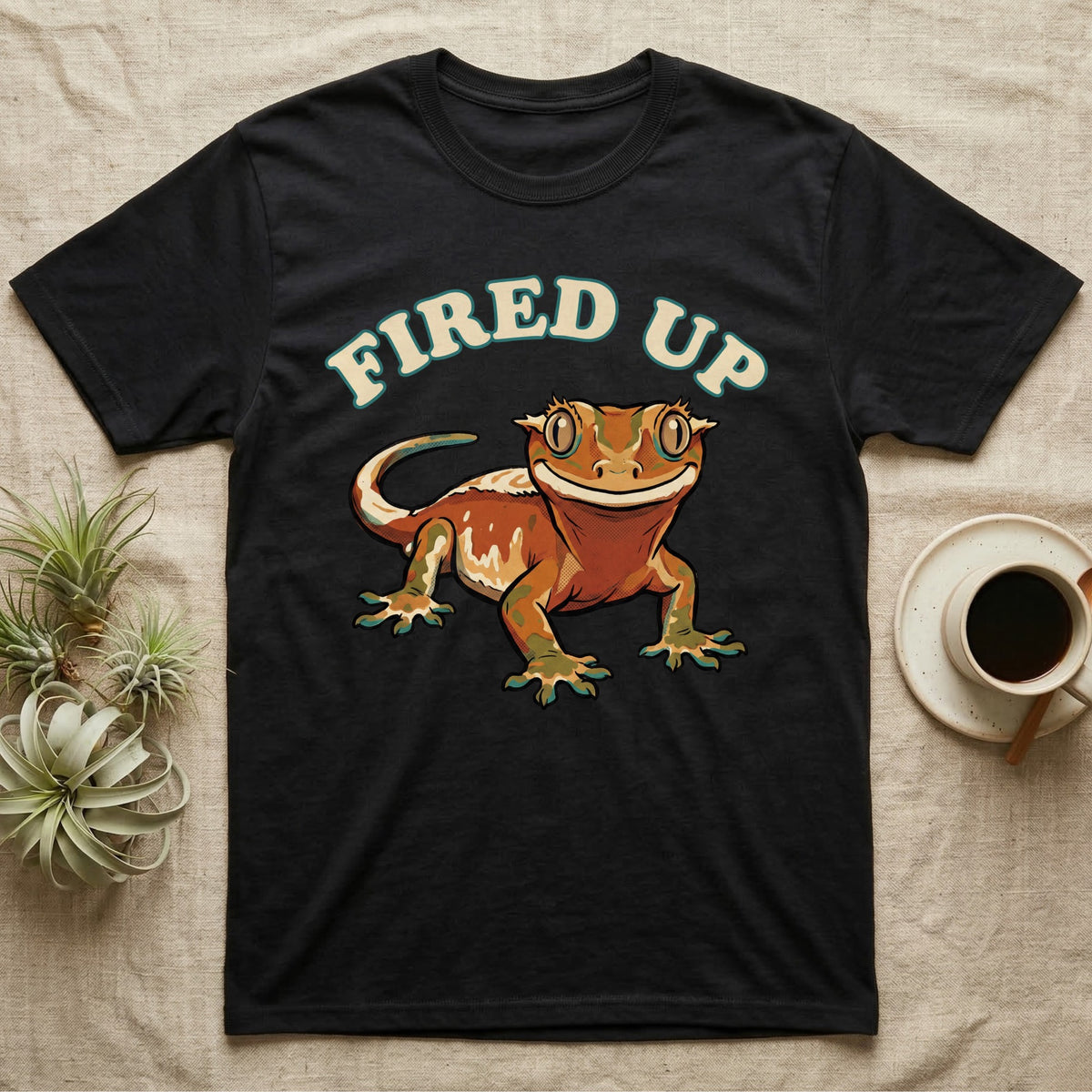 Fired Up Crested Gecko T-Shirt in Black — Retro 90s-style illustration of a fired-up crested gecko under a bold arc headline reading Fired Up.