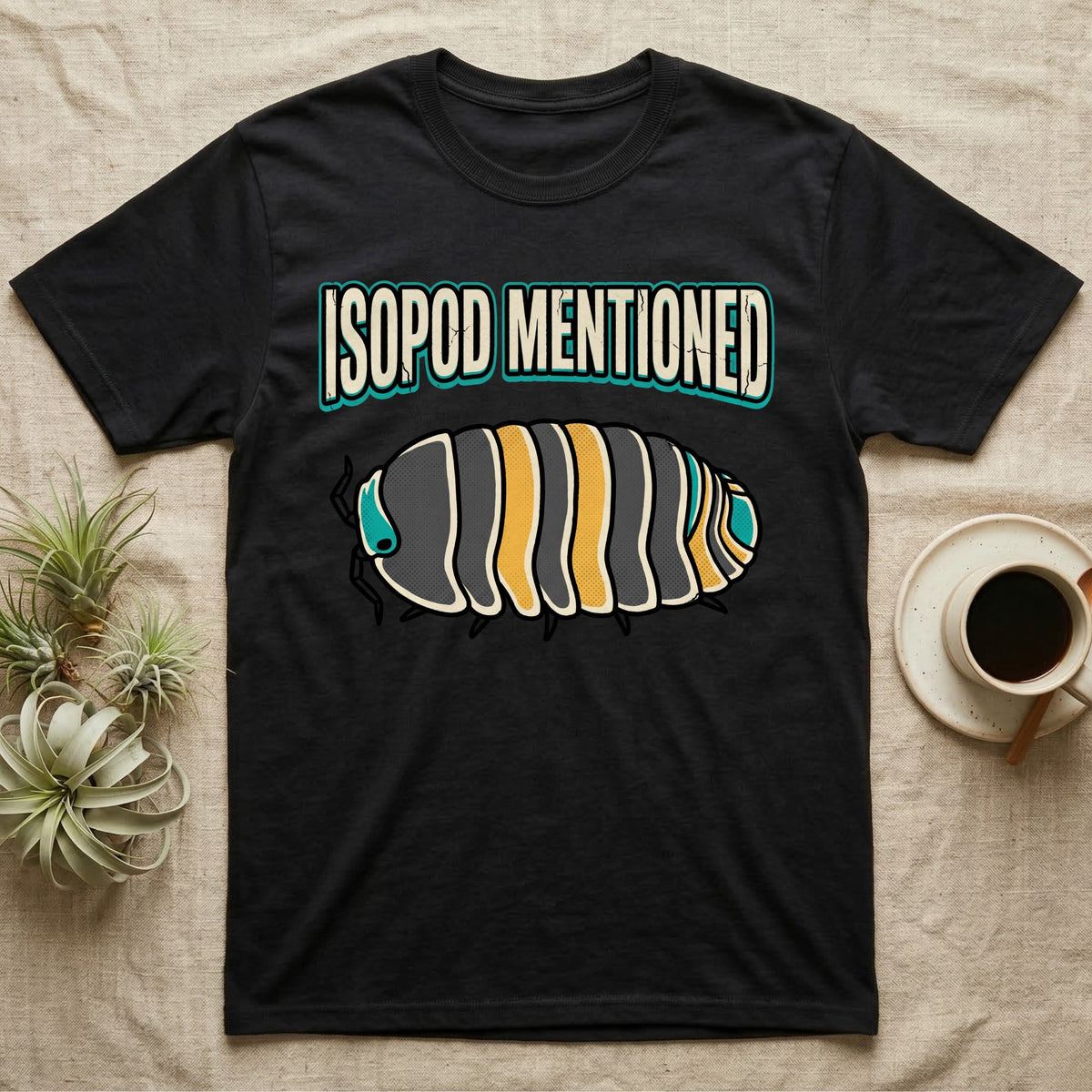 Isopod Mentioned T-Shirt in Black — Bold-vector illustration of a rubber-ducky Cubaris isopod hero under big block caps reading Isopod Mentioned.