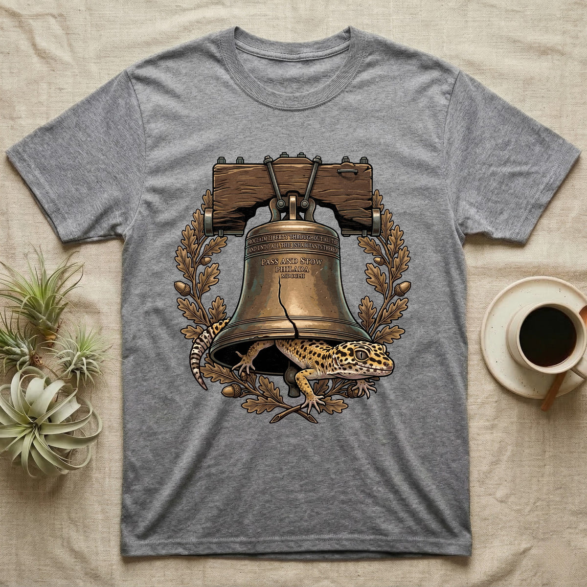 Leopard Gecko Liberty Bell T-Shirt in Sport Grey — Engraved leopard gecko emerging beneath the bronze Liberty Bell inside an oak-leaf and acorn wreath.