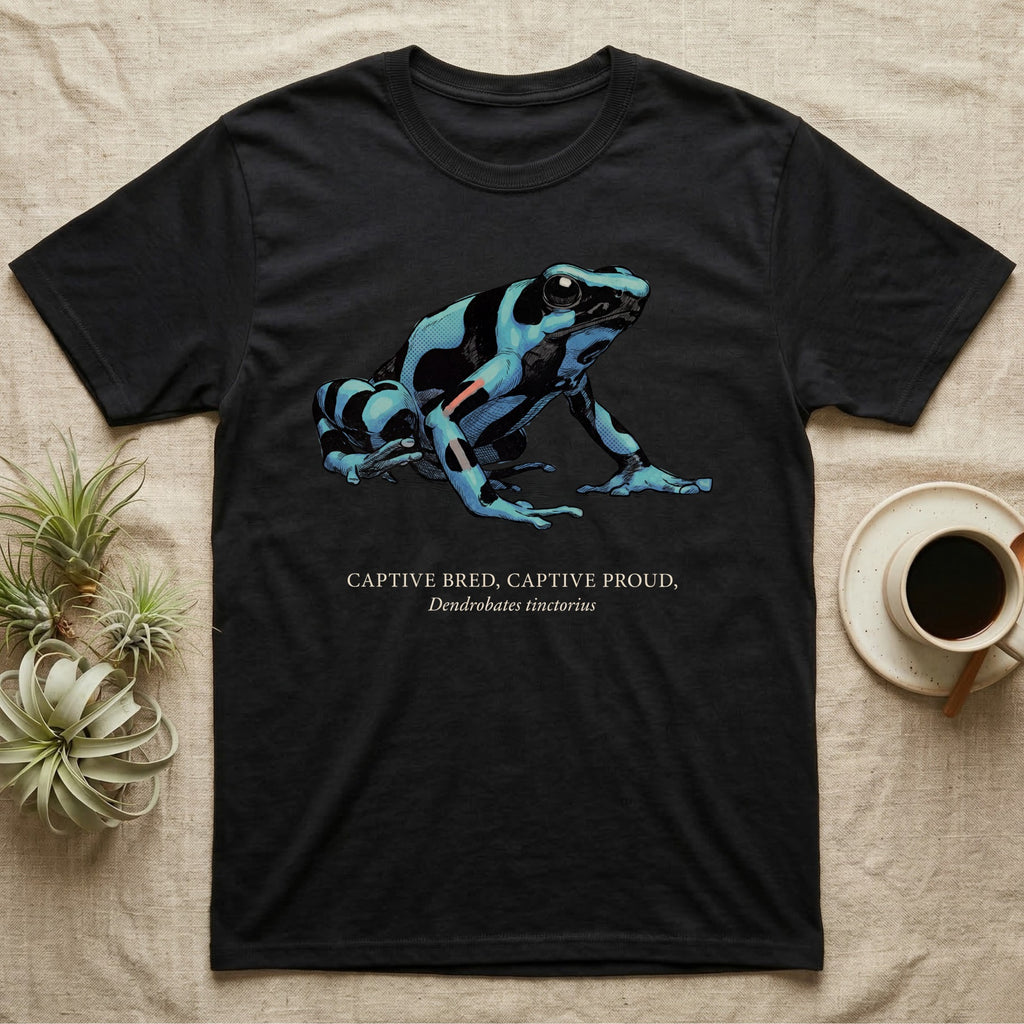 Captive Bred Frog T-Shirt in Black — Naturalist-plate illustration of a healthy dyeing dart frog above a serif creed reading Captive Bred Captive Proud.