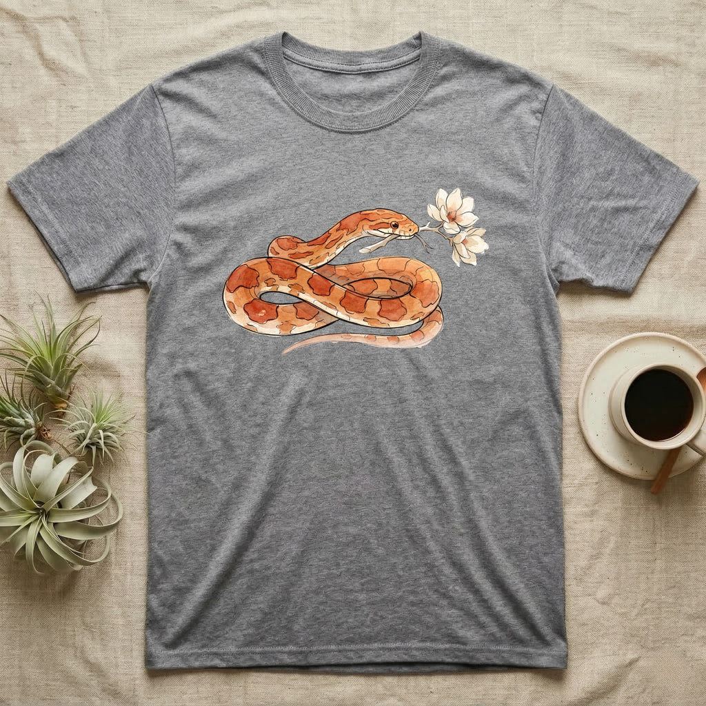 Corn Snake Blossom T-Shirt in Sport Grey — Watercolor illustration of an orange-and-cream corn snake holding a magnolia blossom sprig, on a dark grey t-shirt.