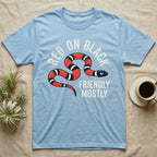 Milk Snake Friendly T-Shirt in Light Blue — Worn screen-print of a red, black and cream banded milk snake under the cream words Red On Black, Friendly, Mostly