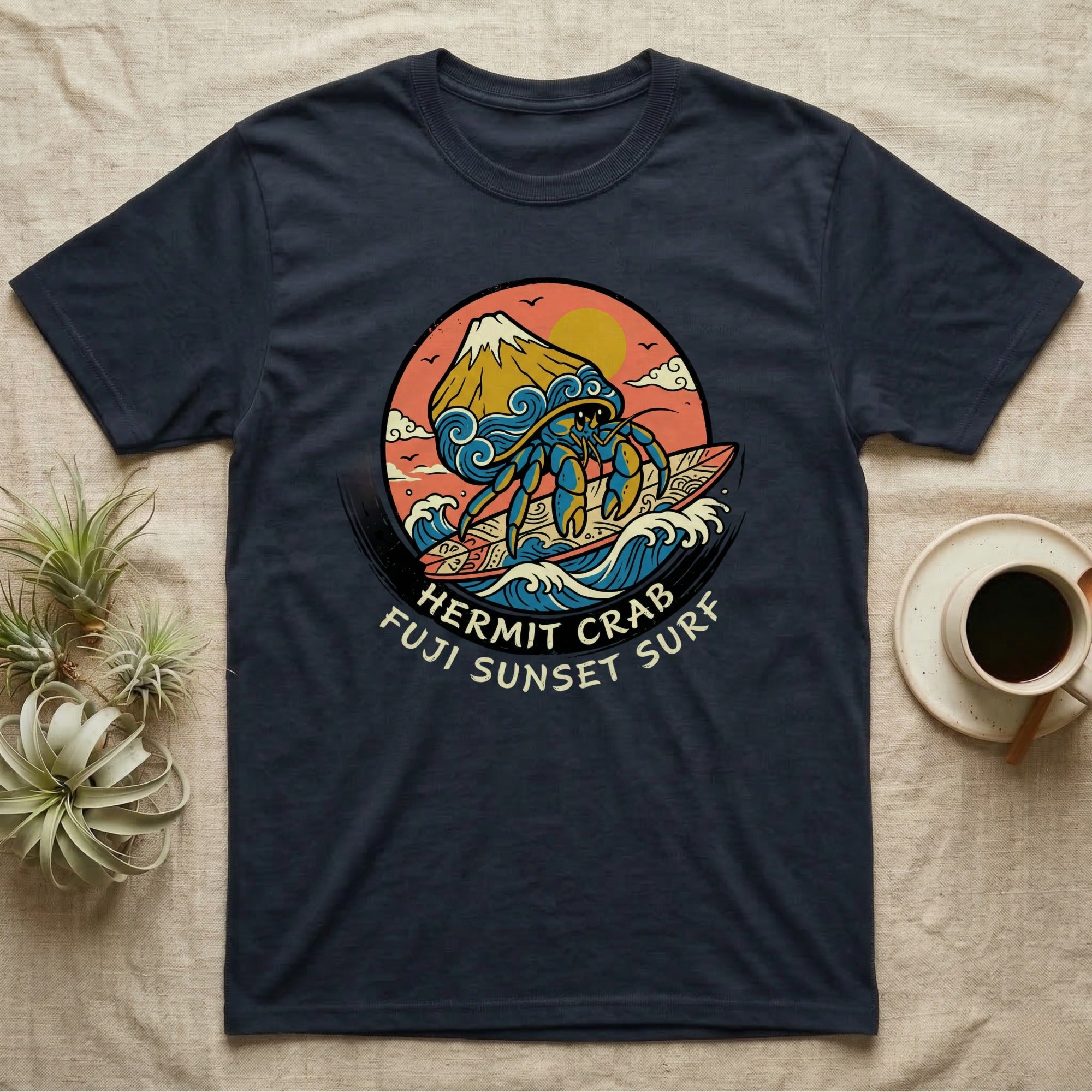 Navy t-shirt with a hermit crab surfing a wave in front of Mount Fuji at sunset.