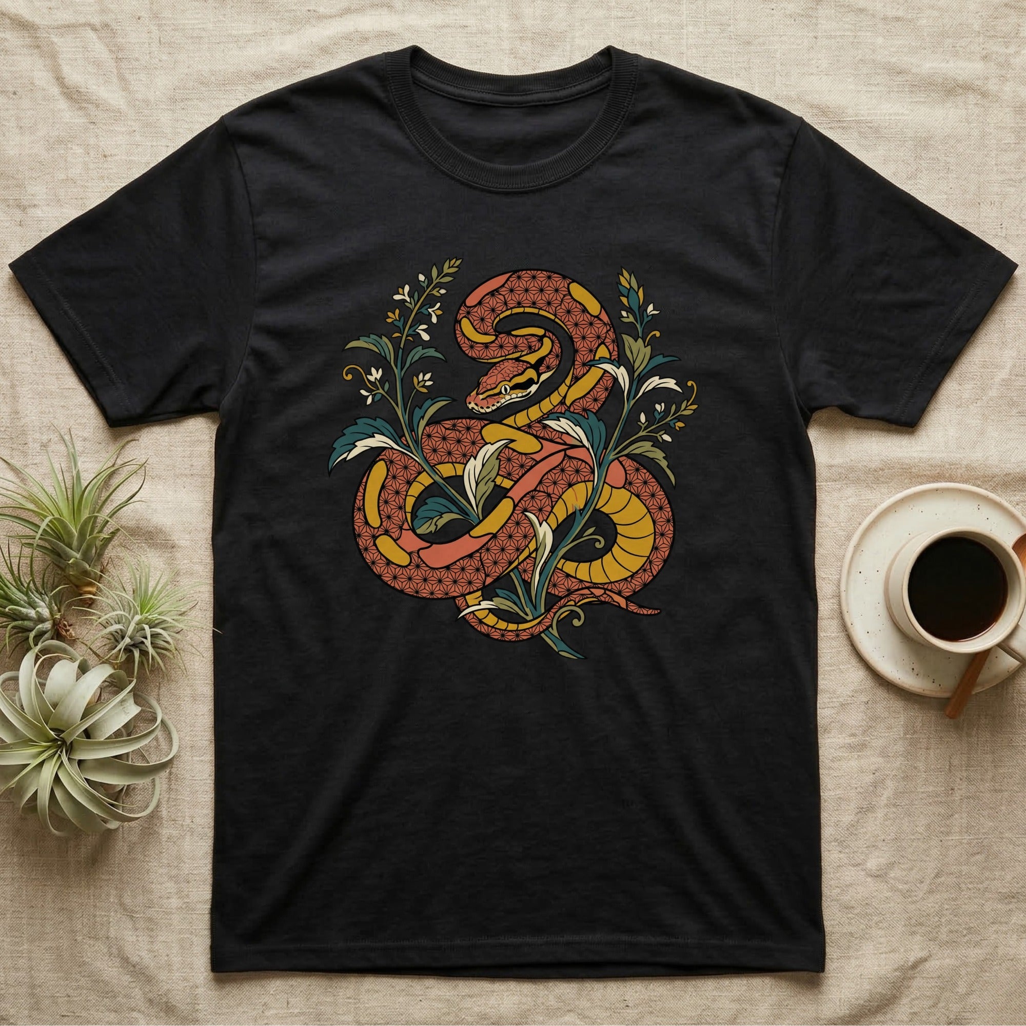 Black t-shirt with a coiled orange snake and floral design.