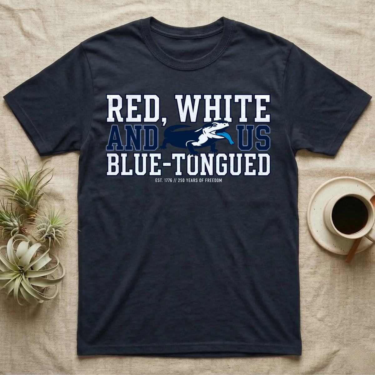 Blue-Tongued Skink 1776 T-Shirt in Navy — Navy and white blue-tongued skink with tongue out between collegiate text reading Red, White and US Blue-Tongued.