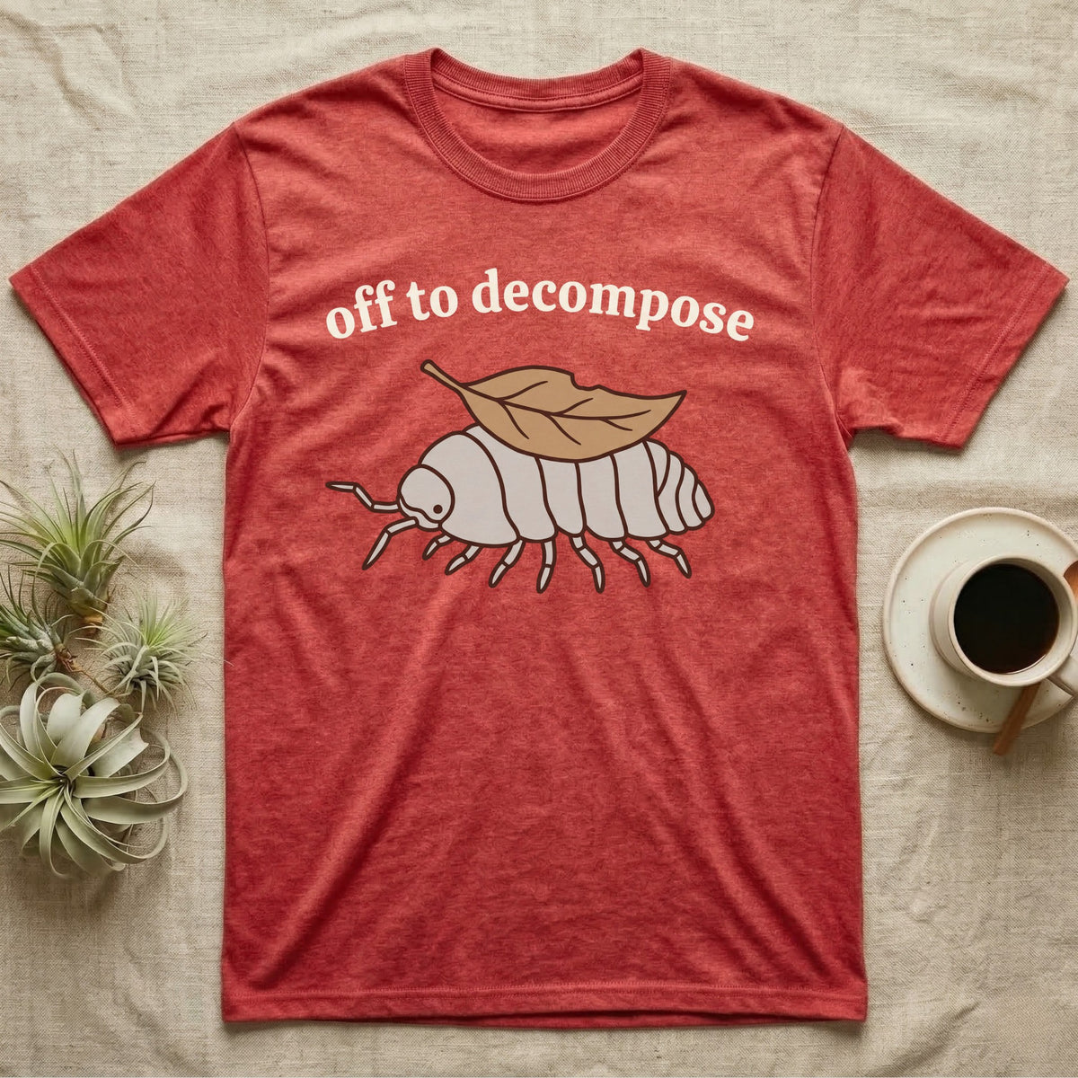 Isopod Decomposer T-Shirt in Heather Red — Minimal doodle of a grey isopod walking off with a dead leaf on its back under the words off to decompose