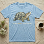 Box Turtle Wiggle T-Shirt in Light Blue — Retro-illustration of a box turtle mid shell-scratch with a hand-drawn arrow at its wiggling rear and a deadpan marker caption.